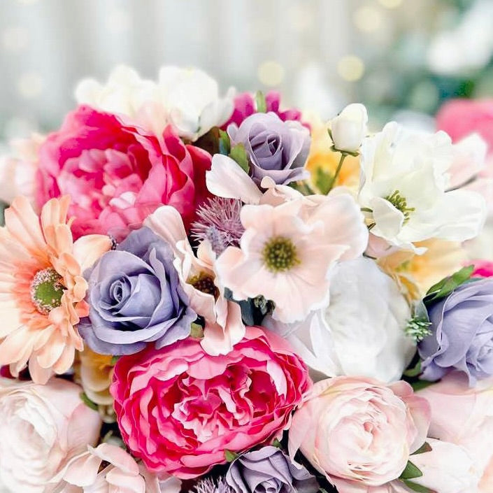 Bouquet of colorful flowers with pink, purple, and white tones.